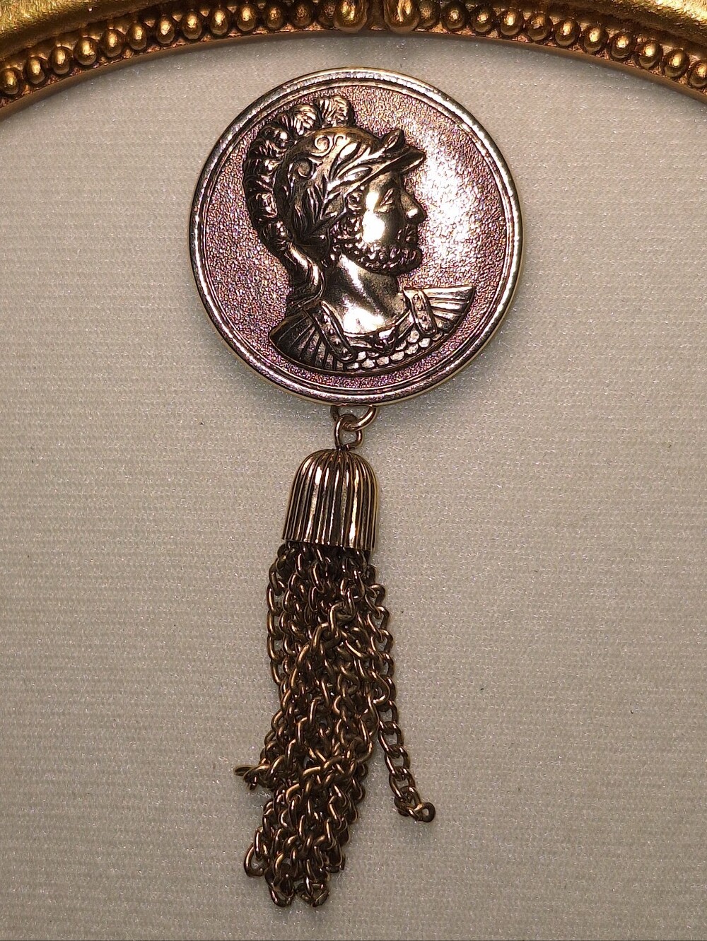 Vntage Sarah Coventry gold tone faux Roman soldier coin brooch with tassel